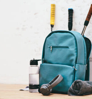 Shot of a sports bag and other items in an empty squash court