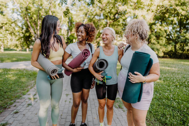 Group of women practicing yoga in the park