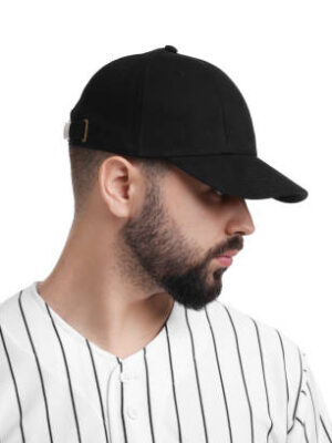 Man in stylish black baseball cap on white background