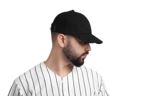 Man in stylish black baseball cap on white background